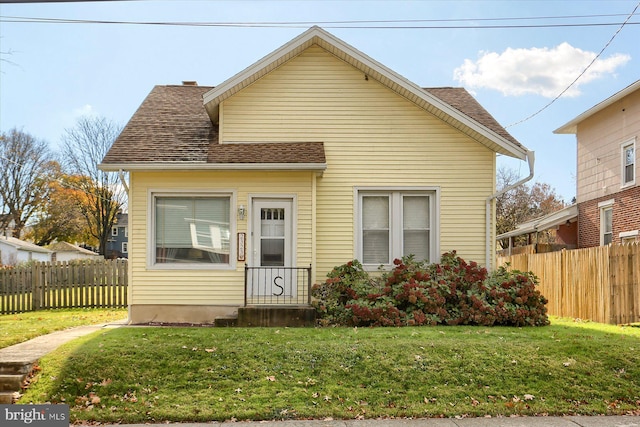 bungalow-style home featuring a front yard