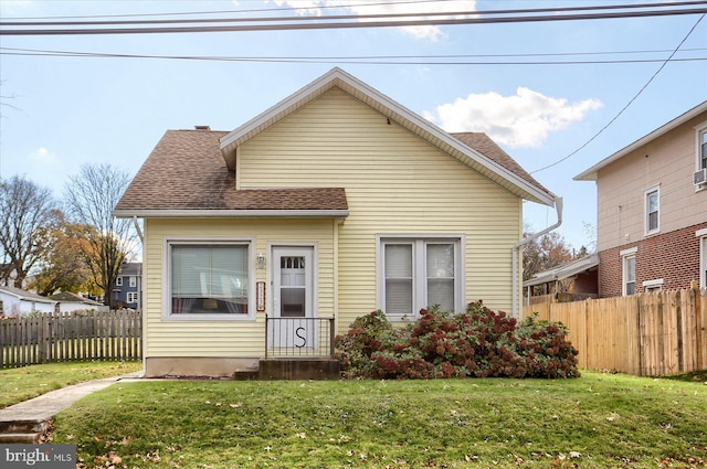 bungalow-style house featuring a front yard