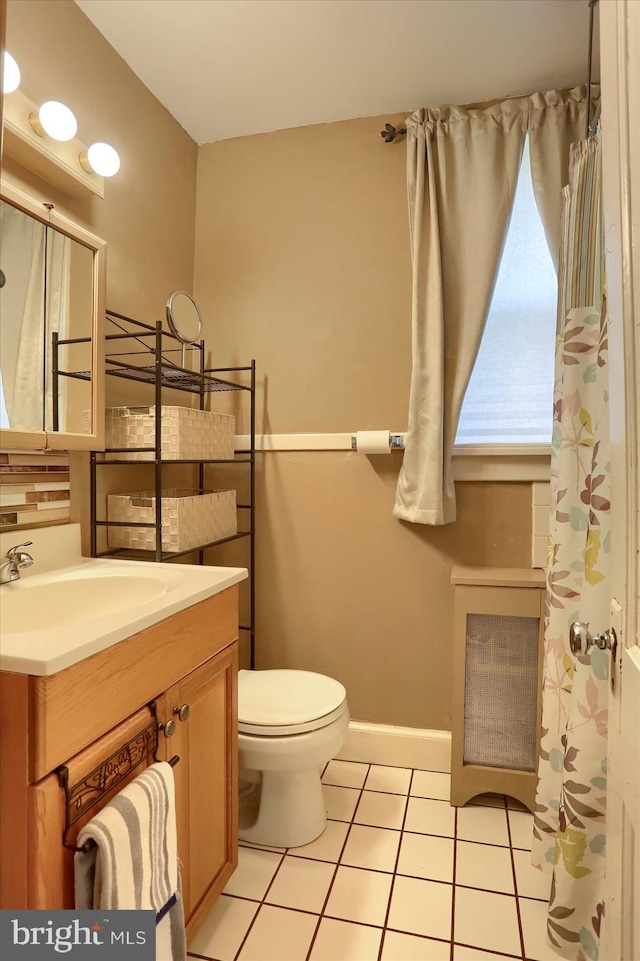 bathroom featuring tile patterned floors, vanity, and toilet