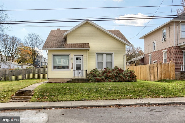 bungalow-style home with a front lawn