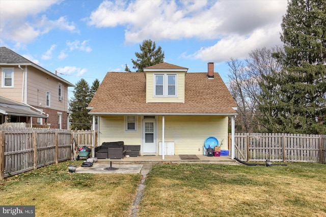 back of property featuring a patio area and a yard