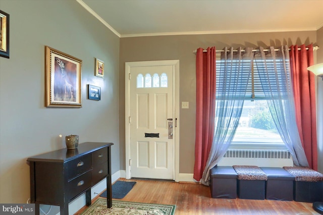 entrance foyer featuring hardwood / wood-style flooring and ornamental molding