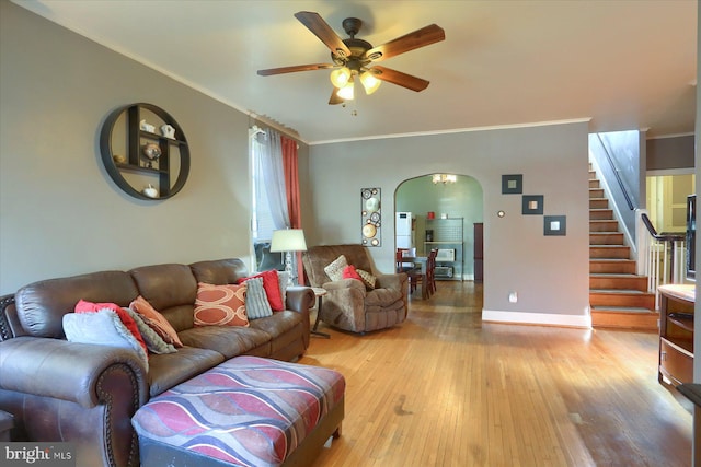 living room with ceiling fan, light hardwood / wood-style flooring, and ornamental molding