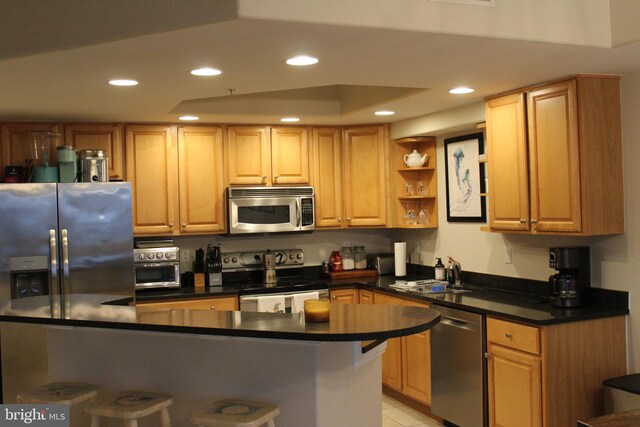 18 41st St Unit 304, Ocean City, MD 21842 - kitchen with stainless steel appliances, recessed lighting, dark countertops, light tile patterned flooring, and a sink