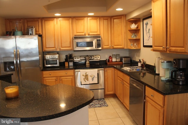 kitchen featuring sink, light tile patterned floors, and stainless steel appliances