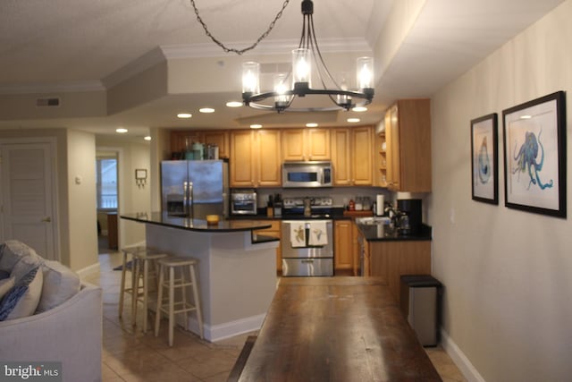 18 41st St Unit 304, Ocean City, MD 21842 - kitchen with stainless steel appliances, a chandelier, ornamental molding, dark countertops, and a center island