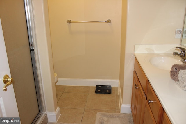 18 41st St Unit 304, Ocean City, MD 21842 - bathroom featuring tile patterned flooring, vanity, baseboards, an enclosed shower, and toilet