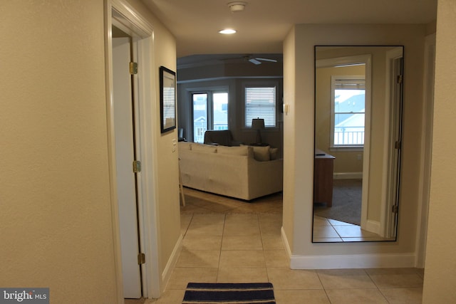 hall featuring light tile patterned floors