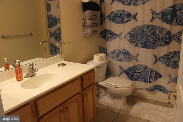 bathroom featuring toilet, vanity, tile patterned floors, and a shower with shower curtain