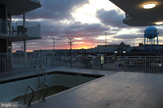 view of pool at dusk