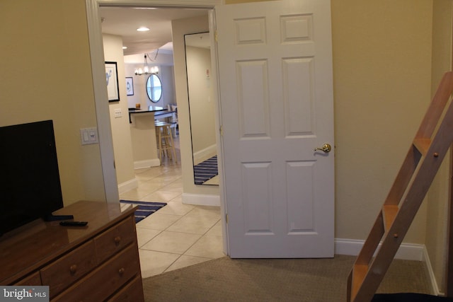 18 41st St Unit 304, Ocean City, MD 21842 - hall featuring a chandelier, light tile patterned flooring, and baseboards