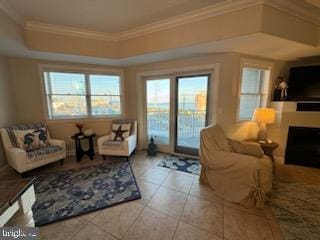 living room with a raised ceiling, light tile patterned floors, and ornamental molding