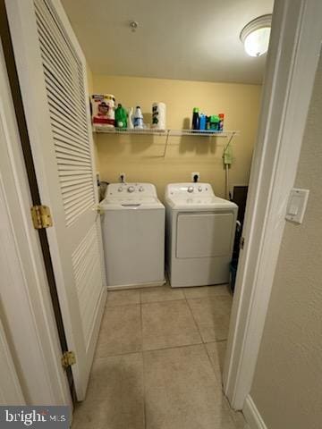 18 41st St Unit 304, Ocean City, MD 21842 - laundry room featuring washing machine and dryer and light tile patterned floors
