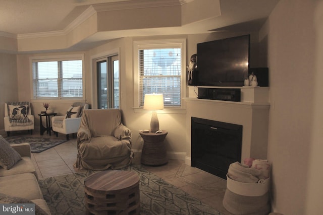18 41st St Unit 304, Ocean City, MD 21842 - tiled living room with ornamental molding, a tray ceiling, and a glass covered fireplace