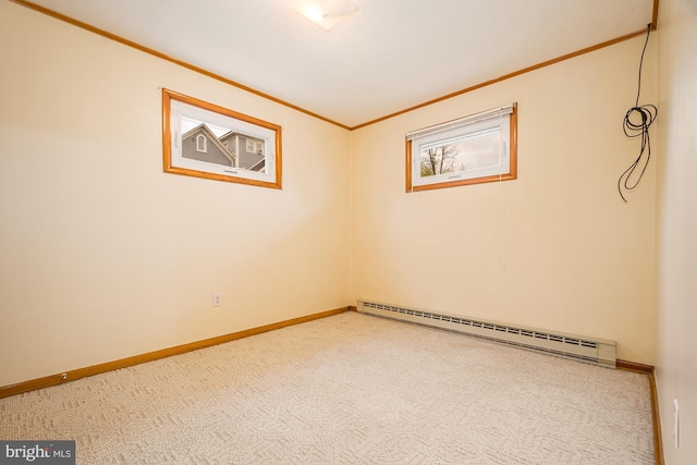 carpeted empty room with baseboard heating and crown molding