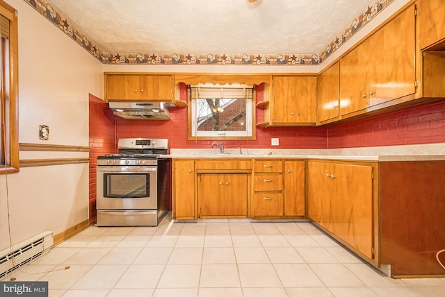 kitchen with stainless steel range with gas cooktop, a baseboard heating unit, backsplash, extractor fan, and a textured ceiling