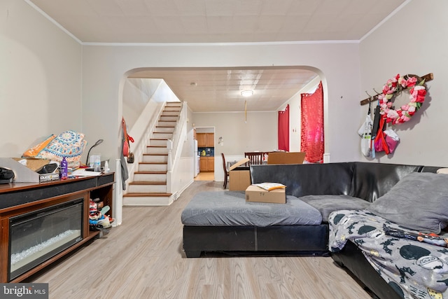 living room featuring light hardwood / wood-style flooring and ornamental molding