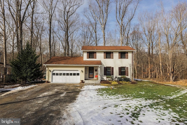 view of front of property featuring a garage and a yard