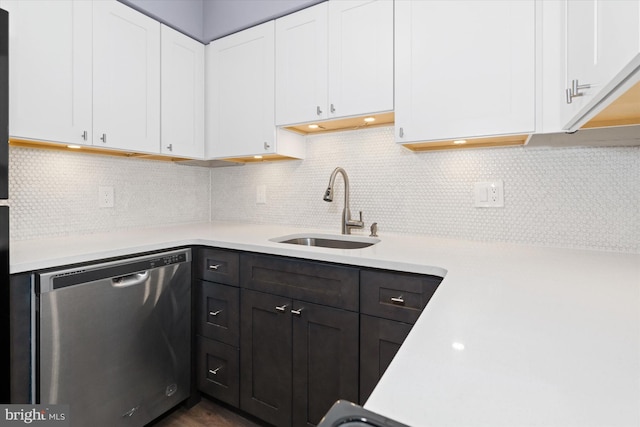 kitchen with white cabinets, decorative backsplash, sink, and stainless steel dishwasher