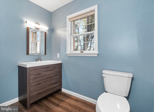 bathroom featuring vanity, hardwood / wood-style floors, and toilet