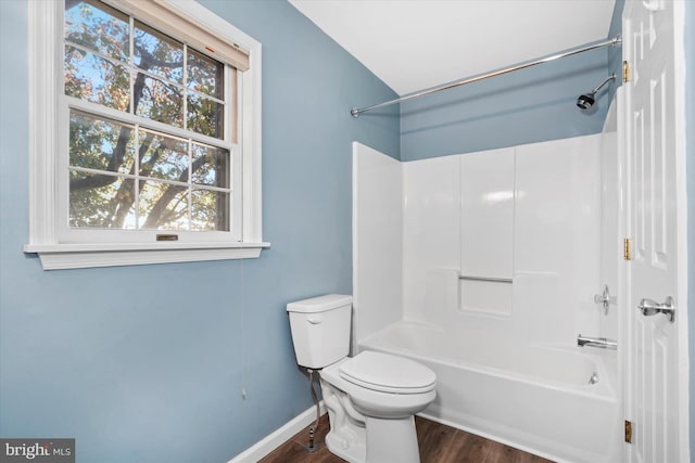 bathroom featuring hardwood / wood-style floors, toilet, and tub / shower combination