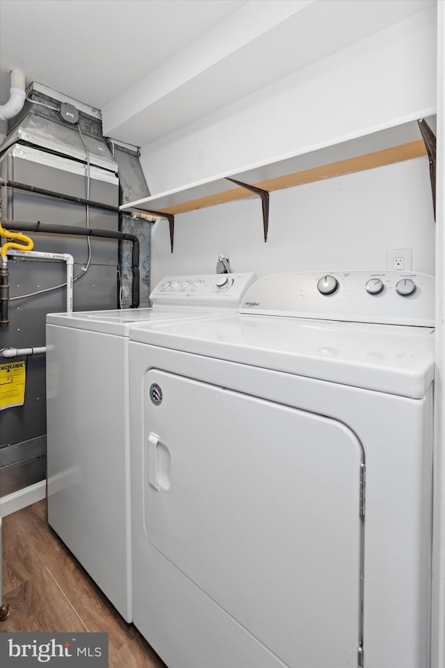 laundry room featuring separate washer and dryer and dark hardwood / wood-style floors