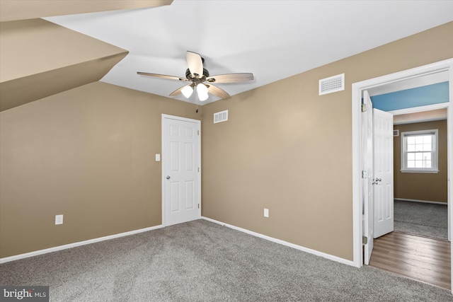 unfurnished bedroom with carpet floors, vaulted ceiling, and ceiling fan