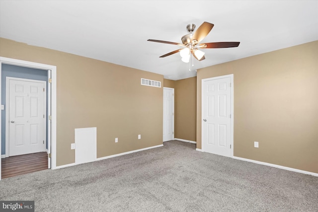 spare room with ceiling fan and carpet flooring