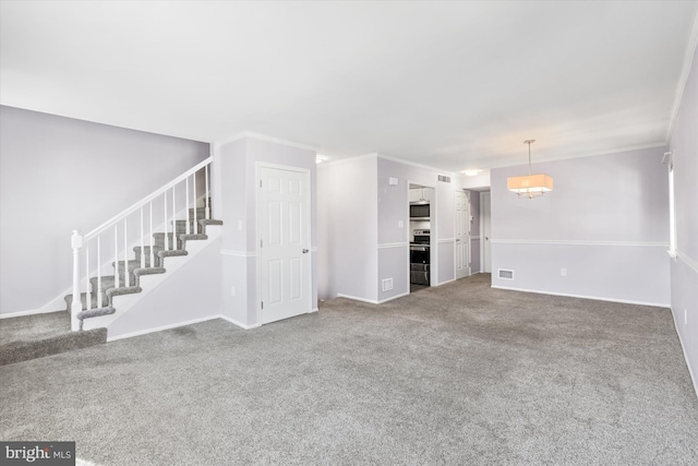 unfurnished living room featuring ornamental molding and carpet floors