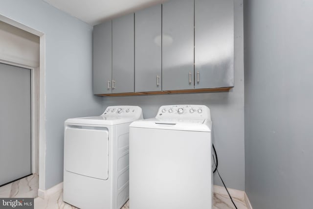 laundry area featuring cabinets and washing machine and clothes dryer