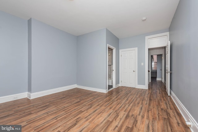 spare room featuring dark wood-type flooring