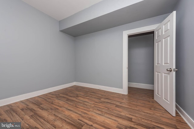 spare room featuring dark wood-type flooring