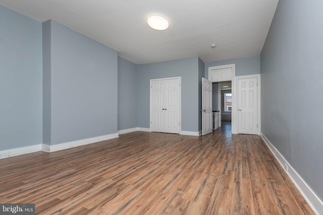 spare room with dark hardwood / wood-style floors