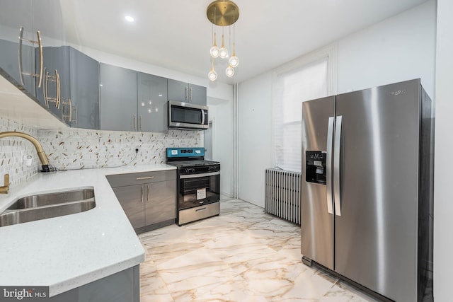 kitchen featuring gray cabinets, sink, pendant lighting, and appliances with stainless steel finishes