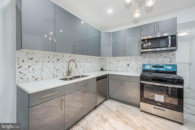 kitchen featuring gray cabinetry, decorative backsplash, sink, and stainless steel appliances