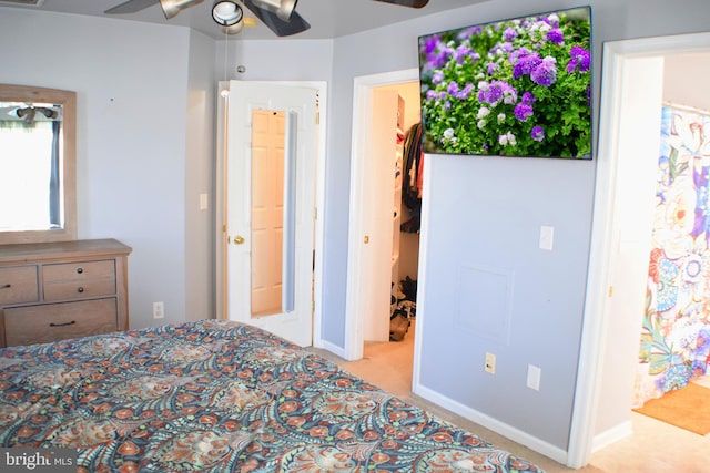 unfurnished bedroom featuring ceiling fan, light carpet, and ensuite bath