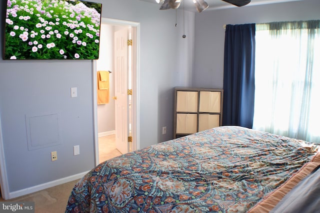 bedroom featuring ceiling fan and light carpet