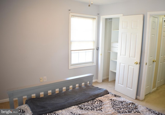 bedroom with light carpet and multiple windows