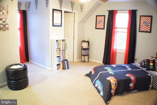 carpeted bedroom with ceiling fan and lofted ceiling