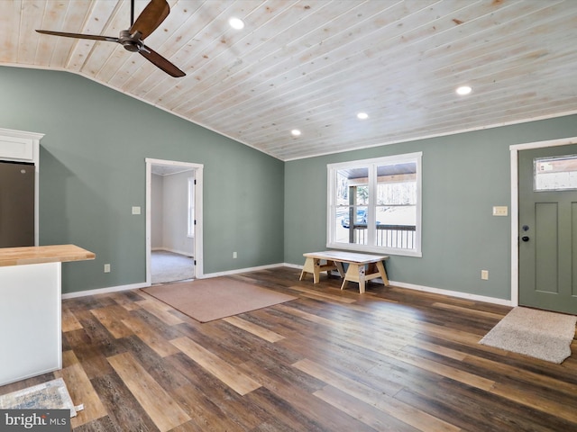 entryway with ceiling fan, dark wood-type flooring, wooden ceiling, and lofted ceiling