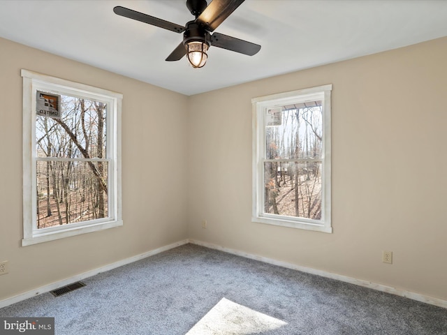 carpeted spare room with ceiling fan