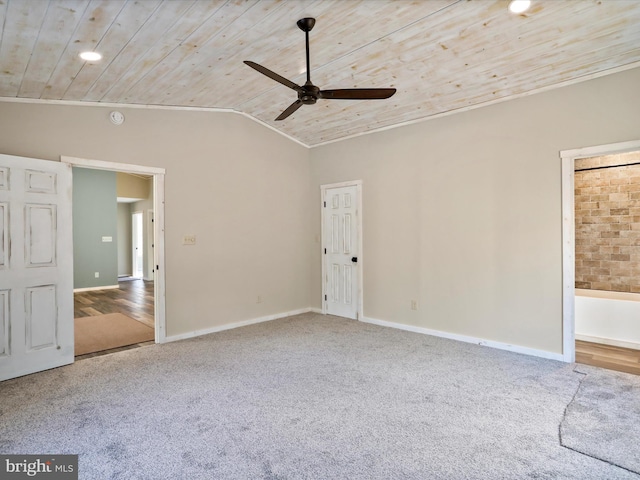 empty room featuring carpet, ceiling fan, wooden ceiling, and vaulted ceiling