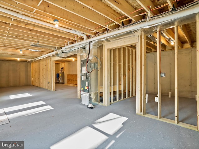 basement with electric water heater and heating unit