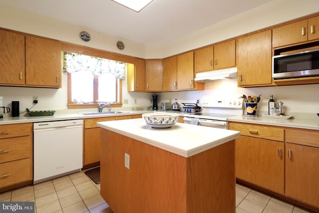 kitchen featuring a center island, sink, light tile patterned floors, and white appliances