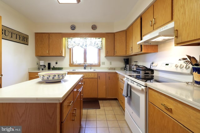 kitchen with sink, white electric range, a center island, and light tile patterned flooring