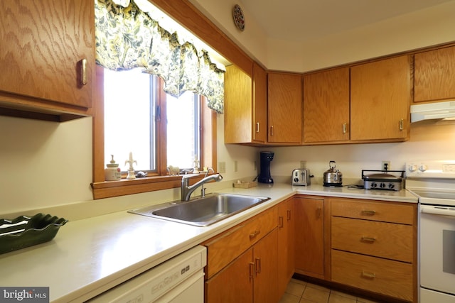 kitchen with white appliances, sink, and light tile patterned floors