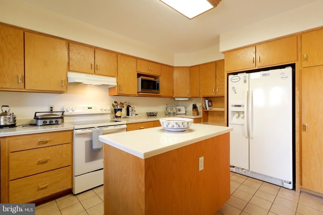 kitchen featuring white appliances, light tile patterned flooring, and a kitchen island