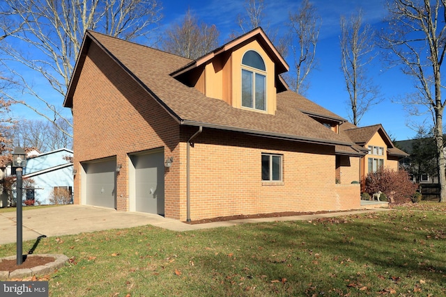 view of side of home featuring a garage and a lawn