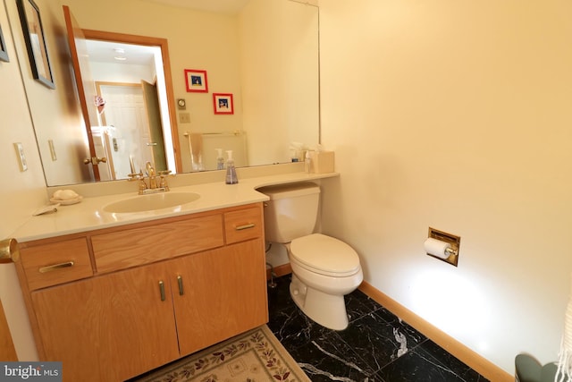 bathroom featuring vanity and toilet