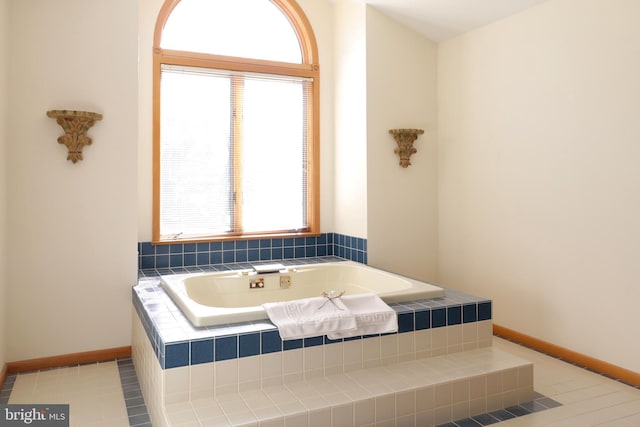 bathroom featuring tile patterned floors and tiled tub